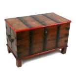 A hardwood trunk with iron strapwork, on block feet, 67cms (26.5ins) wide.