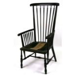 An Arts & Crafts ebonised stick back armchair with upholstered seat, on turned legs joined by an 'H'