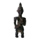 African / Tribal Art. An African fertility figure in the form of a woman holding a baby, 22cms (8.