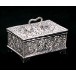 An ornate Indian silver box with all over chased decoration. Embossed to the underside 'Presented by