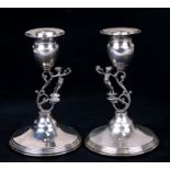 A pair of continental 900 grade silver candlesticks with figural columns, 13cms (5ins) high.
