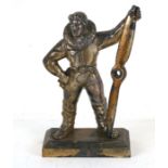 A spelter table lighter in the form of a pilot holding a large propeller, 23cms (9ins) high.