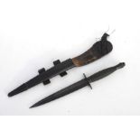 A William Rogers third pattern Commando Knife in its leather scabbard with metal mounts. Marked to