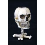 An ivory momento mori match striker in the form of a skull, 7cms (2.75ins) high.