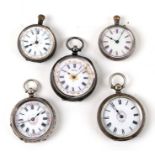 A group of five silver cased open faced fob watches.