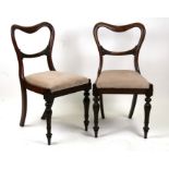 A pair of early 19th century rosewood chairs with upholstered seats.