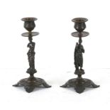 A pair of figural bronze candlesticks, the column in the form of Venus de Milo, 20cms (8ins) high.