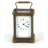 A brass cased carriage clock, the white enamel dial with Roman numerals, 12cms (4.75ins) high.