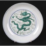 A Chinese famille vert shallow dish decorated with dragons chasing a flaming pearl, blue seal mark