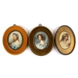 A group of three oval portrait miniatures all depicting young women, the largest 7 by 9cms (2.75