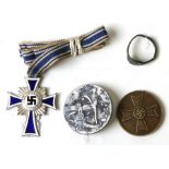 A WWII Third Reich white metal and enamel cross and medallions.