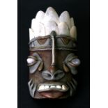 A tribal mask with hardstone eyes and real teeth, 19cms (7.5ins) high.