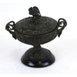 A Grand Tour bronze lidded two-handled urn and cover, decorated in relief with grape and vine, 15cms
