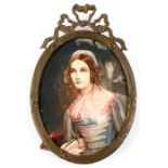 A portrait miniature depicting a young lady wearing a bonnet, in an ornate metal frame, 7 by 8cms (