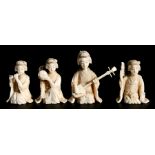 A set of four 19th century Japanese carved ivory geisha girls, three playing instruments and one