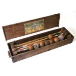 An early 20th century croquet set, cased,