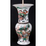 An 18th century famille vert vase of flared form decorated with warriors, converted to a lamp,