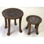 An African hardwood stool, the top with bead inlay decoration, 45cms (17ins) diameter; together with