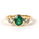 An 18ct gold emerald and diamond three-stone ring, the emerald approx 2ct, the diamonds approx 0.