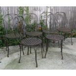 A set of six wrought iron garden chairs with lattice work seats (6).