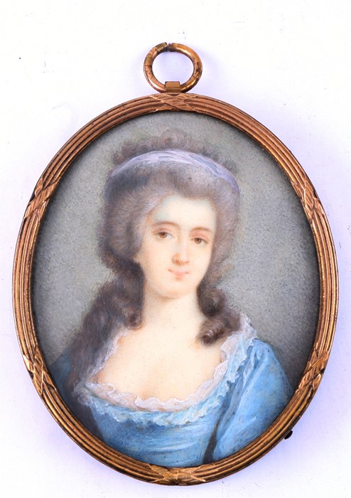 A portrait miniature depicting a lady wearing a blue dress, 5 by 6.5cms (2 by 2.5ins).