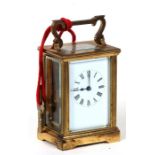 A brass cased carriage clock, the white enamel dial with Roman numerals.11cm (4.25 ins) high
