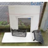 A MARBLE FIRE SURROUND AND BASE ALONG WITH A CAST IRON FIRE GRATE