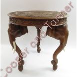 A carved Anglo Indian tripod table, raised on elegant tusk legs each with bone tusks