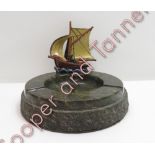 A mid century marble ashtray with detachable painted metal slinging ship
