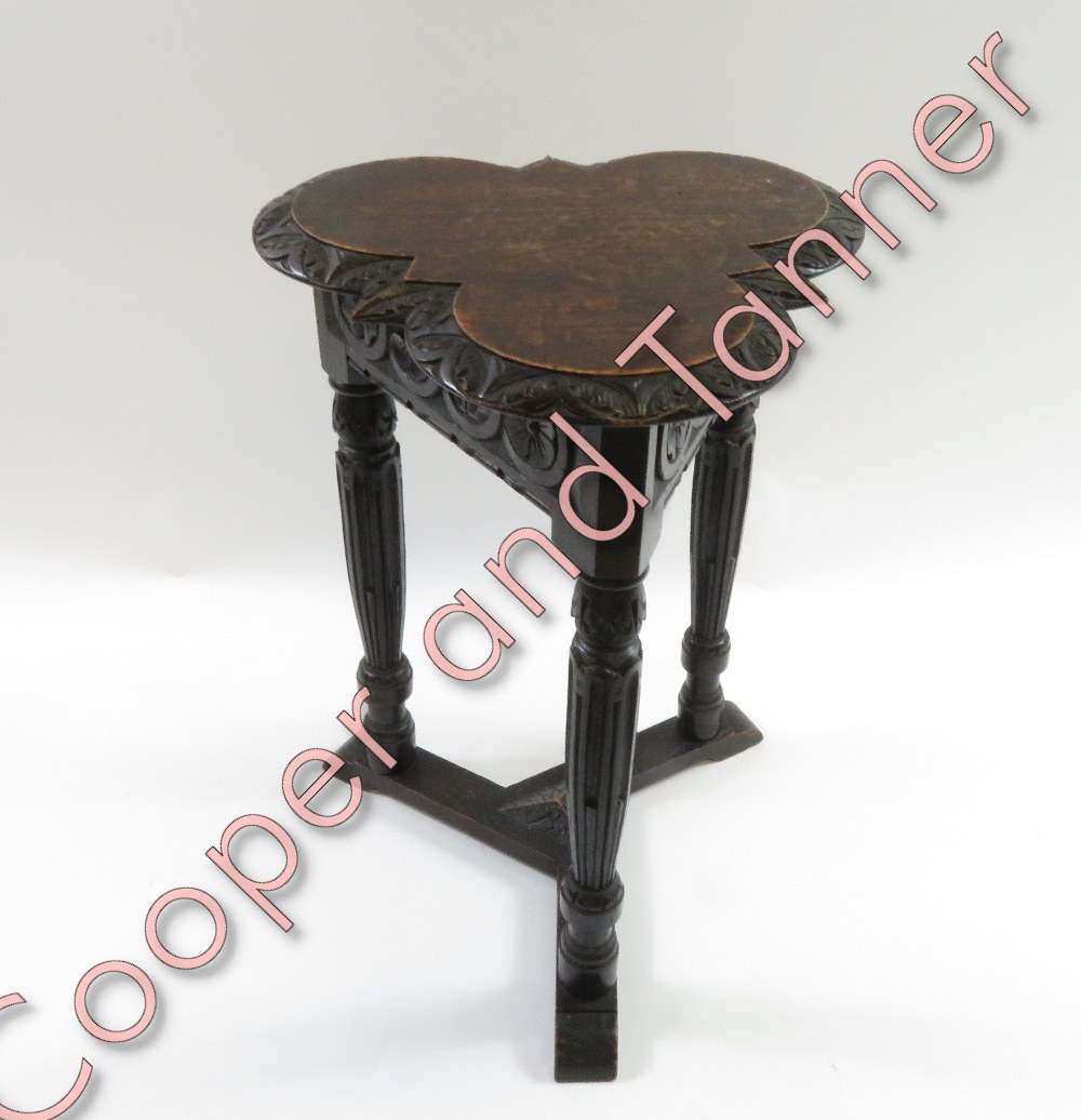 A Victorian oak carved trefoil table, 57cm high, 39cm diameter