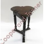 A Victorian oak carved trefoil table, 57cm high, 39cm diameter