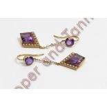 A pair of amethyst and seed pearl drop earrings, the lozenge shaped stones with a border of seed