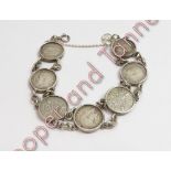 A bracelet of seven silver 3d coins, 20 g gross