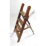 A vintage folding pine stepladder