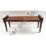 A 19th century mahogany window bench, on turned legs and with scroll ends, 43cm high, 106cm long,