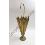 A vintage brass umbrella stand