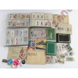 A large collection of cigarette cards and postcards