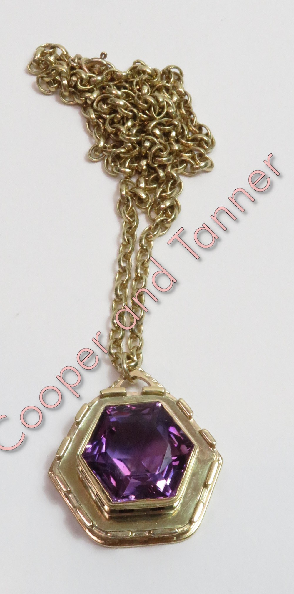 A 9 carat gold amethyst pendant on a 9 carat gold chain, the hexagonal cut stone in a similarly - Image 2 of 2