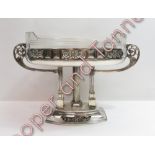 A 20th century silver plated centre piece, raised on three reeded columns, with pierced oval