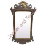 A 20th century mahogany framed mirror with shaped border and gilded Phoenix, 91cm x 50cm