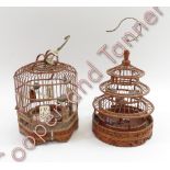 A pair of Chinese wooden birdcages