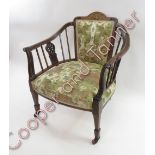 A Victorian inlaid rosewood and walnut open armchair, with scroll arms raised on tapering legs