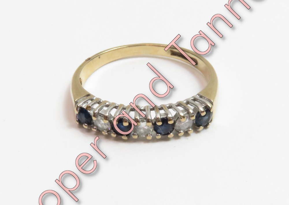 A 9 carat gold sapphire and diamond half hoop ring, finger size M ½, 2 g gross