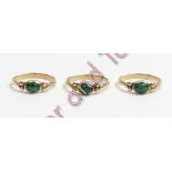 A trio of 9 carat gold rings, each set with an emerald cabochon between a trefoil of beads at each