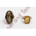 A single stone citrine dress ring, stamped '14K'; with a single stone smoky quartz 9 carat gold