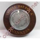 An oak cased wall barometer with gilt painted lettering 'Lovely day for a Guinness'