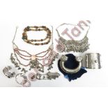 A small collection of Bedouin jewellery, including an Egyptian bangle, beads and other items in