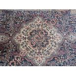 A silk Pakistani carpet on a blue ground with related flower motif border, 299cm x 80cm