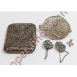 A white metal filigree cigarette case; a large white metal mesh brooch; two white metal stickpins;