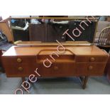 A mid century teak dressing table, with two short and three long drawers, 112cm high, 147cm long,